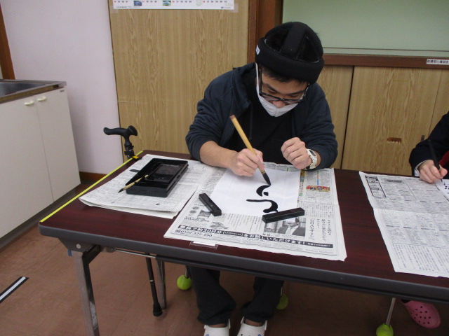 盲生が書初めをおこなう。